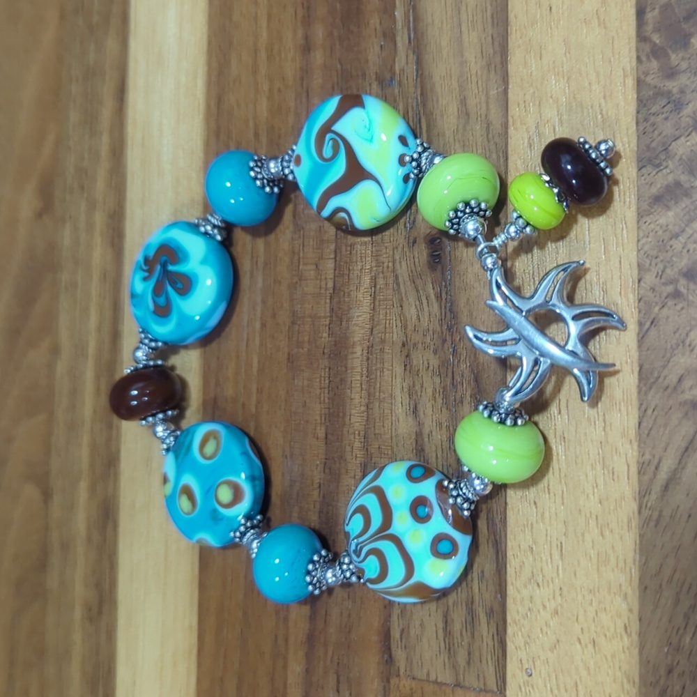 Sterling silver sun clasp and blue and brown glass bead artisan bracelet